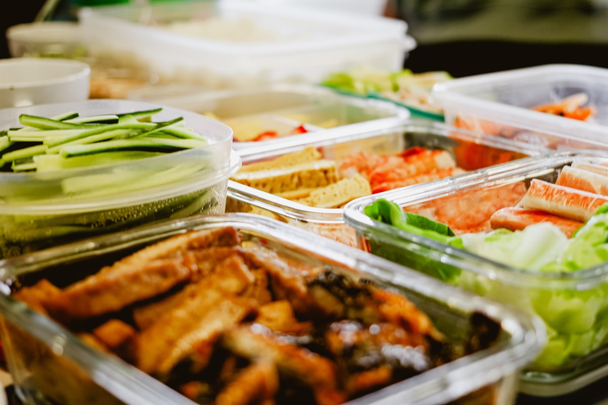 Individual to-go meal boxes with food visible